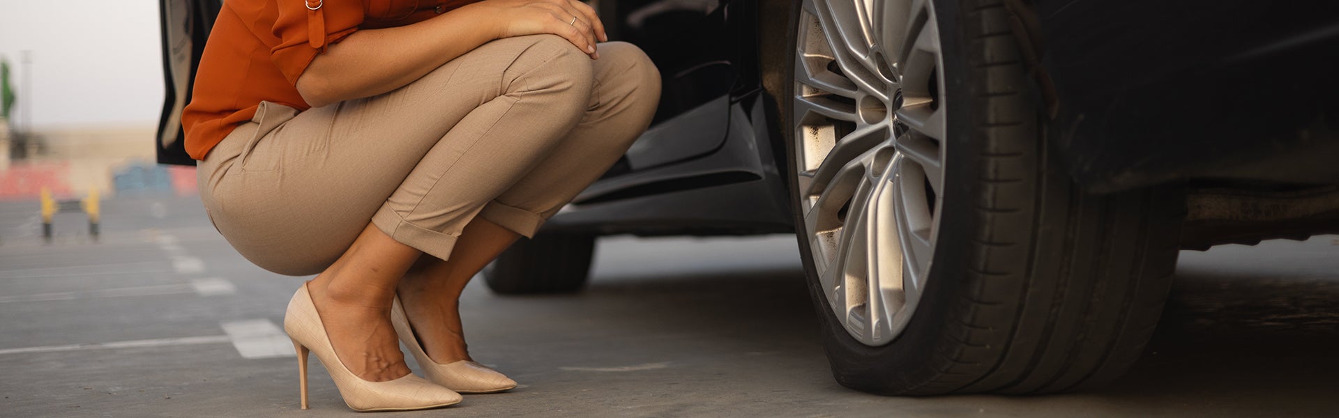 Person inspecting flat tire